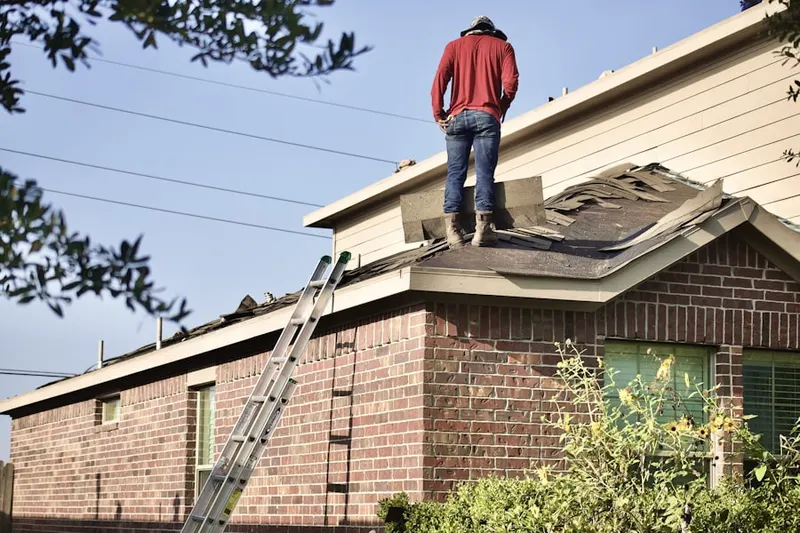 Professional roofer working on a residential roof in Pine Village Estates